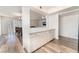 Open-concept dining room with wood-style floors, white walls, and glass sliding doors leading outside at 212 Huntly Rd, Las Vegas, NV 89145