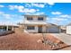 Inviting two-story house with a two car garage, landscaped with rocks instead of grass at 212 Huntly Rd, Las Vegas, NV 89145