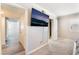 Hallway between bedrooms with TV mounted to wall and doorway to bathroom at 212 Huntly Rd, Las Vegas, NV 89145