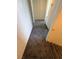 Carpeted hallway with access to multiple rooms, providing seamless flow throughout this level of the home at 212 Huntly Rd, Las Vegas, NV 89145