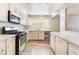 Modern kitchen features white cabinetry, stainless steel appliances, and great natural light at 212 Huntly Rd, Las Vegas, NV 89145