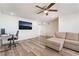 Spacious and airy living room with wood-look flooring, lots of natural light, and ceiling fan at 212 Huntly Rd, Las Vegas, NV 89145