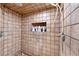 Tiled shower stall featuring shower head and built-in shelving at 212 Huntly Rd, Las Vegas, NV 89145