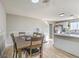 Dining area flowing into a well-lit kitchen with a stainless steel refrigerator at 2129 N Michael Way, Las Vegas, NV 89108