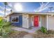 Charming single-story home featuring a vibrant red front door and low maintenance desert landscaping at 2129 N Michael Way, Las Vegas, NV 89108