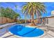 Private backyard pool featuring desert landscaping and a mature palm tree on a sunny day at 2129 N Michael Way, Las Vegas, NV 89108