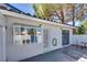 Back patio area with white brick, a security door, and a sliding glass door for indoor/outdoor living at 2141 Twickenham Pl # A, Las Vegas, NV 89108