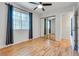 Bedroom features hardwood floors, ceiling fan, closet, and a window with blinds at 2141 Twickenham Pl # A, Las Vegas, NV 89108