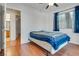 Bedroom features wood floors, ceiling fan, and a doorway that leads to the bathroom at 2141 Twickenham Pl # A, Las Vegas, NV 89108