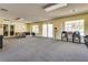 Spacious community room with tables, chairs, and natural light from the windows at 2141 Twickenham Pl # A, Las Vegas, NV 89108