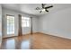 Living room with hardwood floors, light gray walls, a ceiling fan, and a glass door leading to the patio at 2141 Twickenham Pl # A, Las Vegas, NV 89108