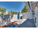 Enclosed back patio featuring white brick, double doors, an AC unit, and a blue entrance gate at 2141 Twickenham Pl # A, Las Vegas, NV 89108