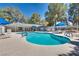 Community pool area with lounge chairs, umbrellas, and a well-maintained pool at 2141 Twickenham Pl # A, Las Vegas, NV 89108