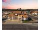 An aerial view of a single-Gathering home with tile roof, three-car garage, and desert landscaping at 2161 Avalon Dr, Laughlin, NV 89029