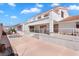 Exterior view of the back of the house with a hot tub, concrete patio and covered porch at 2161 Avalon Dr, Laughlin, NV 89029