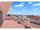 Exterior shot showcasing balcony with red painted concrete, white columns and intricate white metal railing at 2161 Avalon Dr, Laughlin, NV 89029