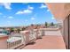 Picture of a red concrete balcony with white columns and a white metal railing with mountain views at 2161 Avalon Dr, Laughlin, NV 89029