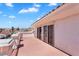 Balcony view of a red concrete patio with white metal railings, columns and sliding glass doors at 2161 Avalon Dr, Laughlin, NV 89029