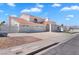 A white single-Gathering home with a tile roof, three-car garage, and desert landscaping at 2161 Avalon Dr, Laughlin, NV 89029