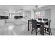 Open kitchen and dining area featuring white cabinetry, granite countertops, and tile floors at 2161 Avalon Dr, Laughlin, NV 89029