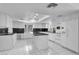 Spacious kitchen featuring white cabinets, a center island, granite counters and tile floors at 2161 Avalon Dr, Laughlin, NV 89029