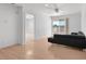 Light-filled living room with wood floors, black sofa, and slider to balcony at 2161 Avalon Dr, Laughlin, NV 89029