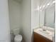 Neutral toned bathroom with a single sink vanity, framed mirror, and toilet at 2525 Sierra Bello Ave # 103, Las Vegas, NV 89106