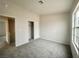 Bright bedroom features neutral carpeting, an adjacent closet, and a large window at 2525 Sierra Bello Ave # 103, Las Vegas, NV 89106