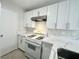 Kitchen showcasing new cabinets, quartz countertops, and a range hood at 2525 Sierra Bello Ave # 103, Las Vegas, NV 89106