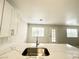 Kitchen island featuring quartz countertop, stainless sink, and view of the dining area at 2525 Sierra Bello Ave # 103, Las Vegas, NV 89106