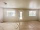 Bright living room featuring neutral walls, tile flooring, and a door with multiple windows for natural light at 2525 Sierra Bello Ave # 103, Las Vegas, NV 89106