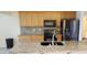 The kitchen has stainless steel appliances, granite counters, and wooden cabinets at 2731 W Huron Ln, Pahrump, NV 89048