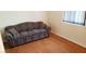 A living room featuring hardwood floors, a couch, and a window at 2731 W Huron Ln, Pahrump, NV 89048