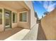 Side patio featuring neutral stucco and hardscape at 2756 Strathblane Ave, Henderson, NV 89044