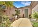 Inviting courtyard featuring desert landscaping, a small seating area, stucco walls and a green front door at 2756 Strathblane Ave, Henderson, NV 89044