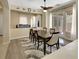 Well-lit dining room with wood floors, modern lighting, and French doors to the patio at 2756 Strathblane Ave, Henderson, NV 89044