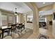 Bright dining room with wood floors, modern lighting, and an open view of the living room and kitchen at 2756 Strathblane Ave, Henderson, NV 89044