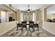 Elegant dining room with wood floors, modern lighting, and views into adjacent rooms at 2756 Strathblane Ave, Henderson, NV 89044