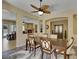 Open dining room with wood floors, modern lighting, and a view of the living room fireplace at 2756 Strathblane Ave, Henderson, NV 89044