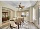 Inviting dining room with wood floors, modern lighting, and a decorative china cabinet at 2756 Strathblane Ave, Henderson, NV 89044