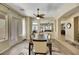 Formal dining room with wood floors, a modern ceiling fan, and neutral decor and access to an outdoor living space at 2756 Strathblane Ave, Henderson, NV 89044