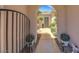 Charming front entrance featuring an arched walkway, landscaped surroundings, and a secured gate at 2756 Strathblane Ave, Henderson, NV 89044