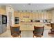 Large island in this kitchen offers bar stool seating, extra space, and ample storage at 2756 Strathblane Ave, Henderson, NV 89044