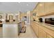 Well-lit kitchen features a large island, stainless appliances, ample counter space, and natural wood cabinetry at 2756 Strathblane Ave, Henderson, NV 89044