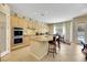 Well-equipped kitchen featuring stainless steel appliances, a breakfast bar, and a view of the pool through the window at 2756 Strathblane Ave, Henderson, NV 89044