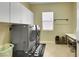 Laundry room with appliances, cabinets, and countertop space at 2756 Strathblane Ave, Henderson, NV 89044