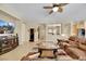 Modern living room with an open floor plan, tile floors, a leather sectional, and an entertainment center with a TV at 2756 Strathblane Ave, Henderson, NV 89044