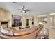 Elegant living room with a large sectional sofa, fireplace, entertainment center, and open access to the dining area at 2756 Strathblane Ave, Henderson, NV 89044