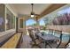 Inviting covered patio with dining area, shuffleboard, and a view of the sparkling pool and lush landscaping at 2756 Strathblane Ave, Henderson, NV 89044