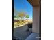 View of the backyard, featuring desert landscaping, mature trees, and a seating area at 2764 Leys Burnett Ave, Henderson, NV 89044